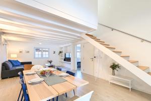 a dining room and living room with a table and a staircase at Ao Pé da Sé next to Braga Cathedral By Sé Apartamentos in Braga