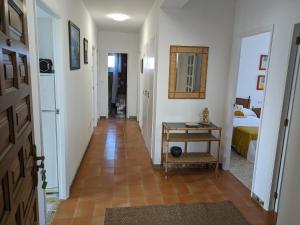 a hallway with a room with a bed and a table at apartamento Sol in O Grove