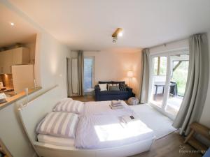 a bedroom with a bed and a living room at friesen-nest-spo in Böhl