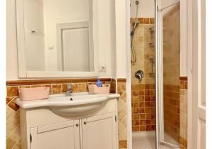 a bathroom with a sink and a shower at Le Residenze sul mare B6 in Porto Ottiolu +32 photos