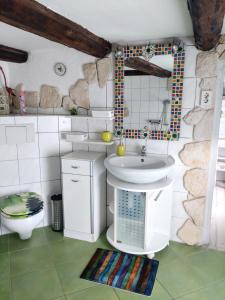 a bathroom with a sink and a toilet at Daheim in Rinteln +27 photos