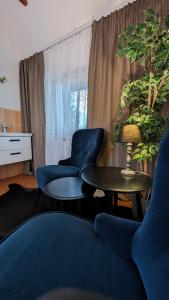a living room with a couch and two chairs and a table at Chata Filoména in Herálec