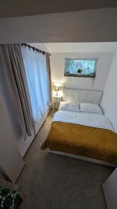 a bedroom with a large bed and a window at Chata Filoména in Herálec +13 photos