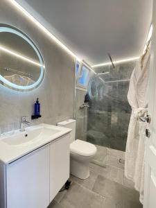 a bathroom with a toilet and a sink and a shower at Gaia Apartments in Hanioti +117 photos