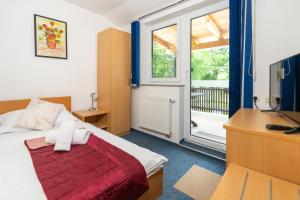 Postel nebo postele na pokoji v ubytování Hotel Center Bohinjsko Jezero