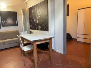a table and chairs in a living room with a couch at IL BORGO APPARTAMENTO in Formigine +4 photos