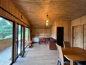 a living room with a table and a couch at Elia Hut Kazbegi in Kazbegi