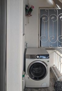 a washer and dryer sitting in a room at Emanuela Holidays Private Parking in Kavala