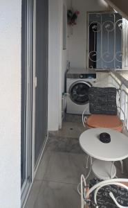a small kitchen with a table and a microwave at Emanuela Holidays Private Parking in Kavala