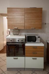 a kitchen with a stove and a microwave at Lido Camaiore - Appartamento Il Pinolo in Camaiore +6 photos