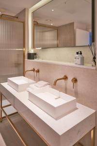 a bathroom with two sinks and a mirror at The Store in Oxford