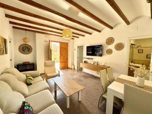 a living room with a couch and a table at Casa en la playa de los Arenales in Arenales del Sol