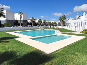 a swimming pool in the yard of a villa at Apartment Orihuela Costa Golf 650 in Los Dolses