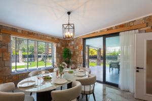 a dining room with a table and chairs at Villa Palmiye by Villa Safiya in Göcek