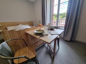 a dining room with a table and chairs and a window at La Maison Lourégo studio Tournesol in Hauterives