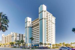 a large white building with palm trees in front of it at WINTER RATES! Ready Set and Relax, Oceanfront Suite w Jetted tub! B 1134 in Myrtle Beach