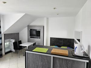 a kitchen with a counter top and a dining room at Pokoje u Marii in Międzyzdroje