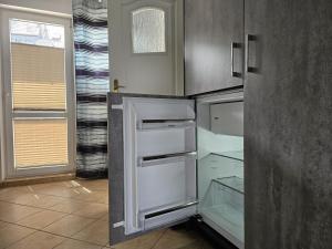 a kitchen with an empty refrigerator in a room at Pokoje u Marii in Międzyzdroje