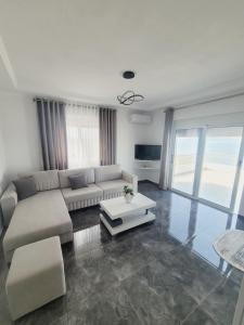a living room with a couch and a table at Vila Makla in Sarandë