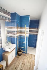 a bathroom with blue walls and a sink at -LE ROOF- Sublime rooftop Concarneau hyper centre in Concarneau