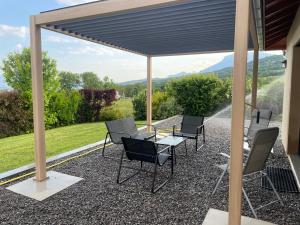 a patio with chairs and a table with a view at LE PIC PONCON in Gap