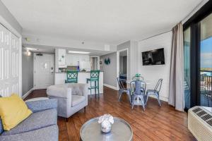 a living room with a couch and a table at Pristine Oceanfront King Suite Best Layout in Bldg 806 in Myrtle Beach
