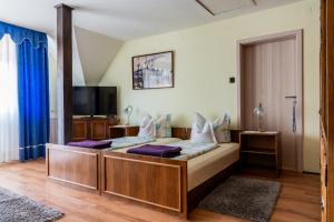 a bedroom with a large bed with purple pillows at Magdalena Apartmanház in Keszthely