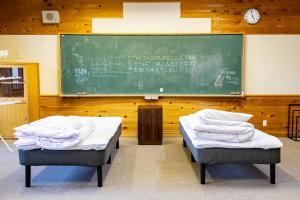 Ліжко або ліжка в номері 馬籠ふるさと学校 Magome Furusato Gakkou