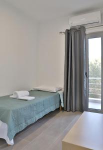 Postel nebo postele na pokoji v ubytování Helios Studios & Apartments