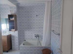a bath tub in a bathroom with blue and white tiles at Ático en Estepona, Malaga in Estepona