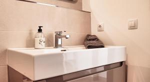 a bathroom sink with a soap dispenser on it at Finca Leilani in Llucmajor +65 photos