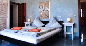 a bed with pillows on it in a room at Finca Leilani in Llucmajor