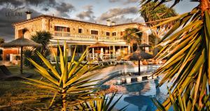 a large building with a pool in front of it at Finca Leilani in Llucmajor