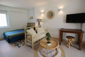 a bedroom with a bed and a table and a desk at Le Lodge in Angoulême