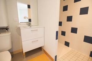 a bathroom with a white toilet and a mirror at Le Lodge in Angoulême +6 photos
