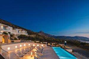 a view of the pool at a hotel at night at Diamond Star Hotel in Falasarna