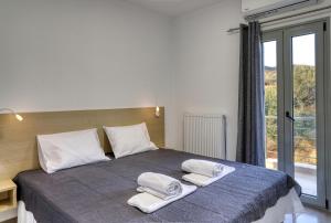 Postel nebo postele na pokoji v ubytování Helios Studios & Apartments