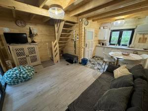 a living room with a couch and a table at Domek rekreacyjny DORAN in Tuczno