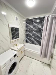 a white bathroom with a sink and a washing machine at Просторная квартира 3 х ком в Новом районе in Shymkent +22 photos