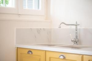 a kitchen counter with a sink and a window at Bright & Cozy House near Beach in Athens +43 photos