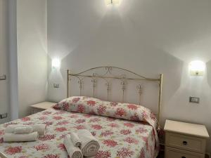 a bedroom with a bed with two towels on it at Fraicol in Santa Domenica +11 photos