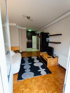 a bedroom with a bed and a black rug at Apartamento Ribadesella playa in Ribadesella