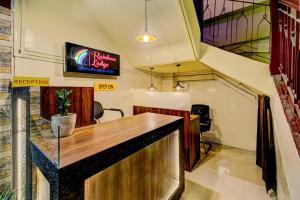 a bar in a room with a sign on the wall at SPOT ON Rainbow Lodge in Guwahati