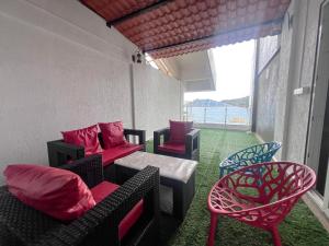 a room with couches and chairs and a window at Zest Eco Villa Montana Lonavala in Lonavala