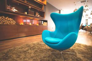 a blue chair sitting on a rug in a room at Motel One Manchester-Piccadilly in Manchester