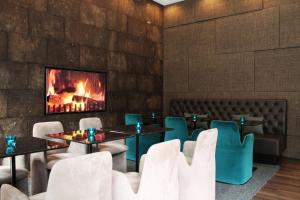 a restaurant with tables and chairs and a fireplace at Motel One Manchester-Piccadilly in Manchester