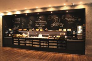 a coffee shop with a black wall at Motel One Manchester-Piccadilly in Manchester