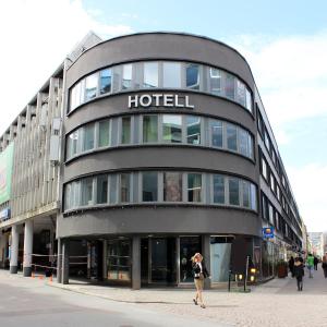 a woman walking in front of a hotel at Comfort Hotel City in Gothenburg