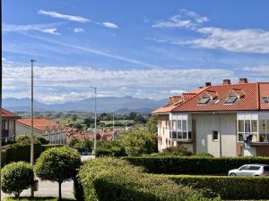 a house with a red roof in a city at Apartamento Loredo in Loredo