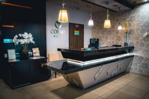 a bar in a restaurant with a counter and lights at Corso Boutique Hotel in Gyula